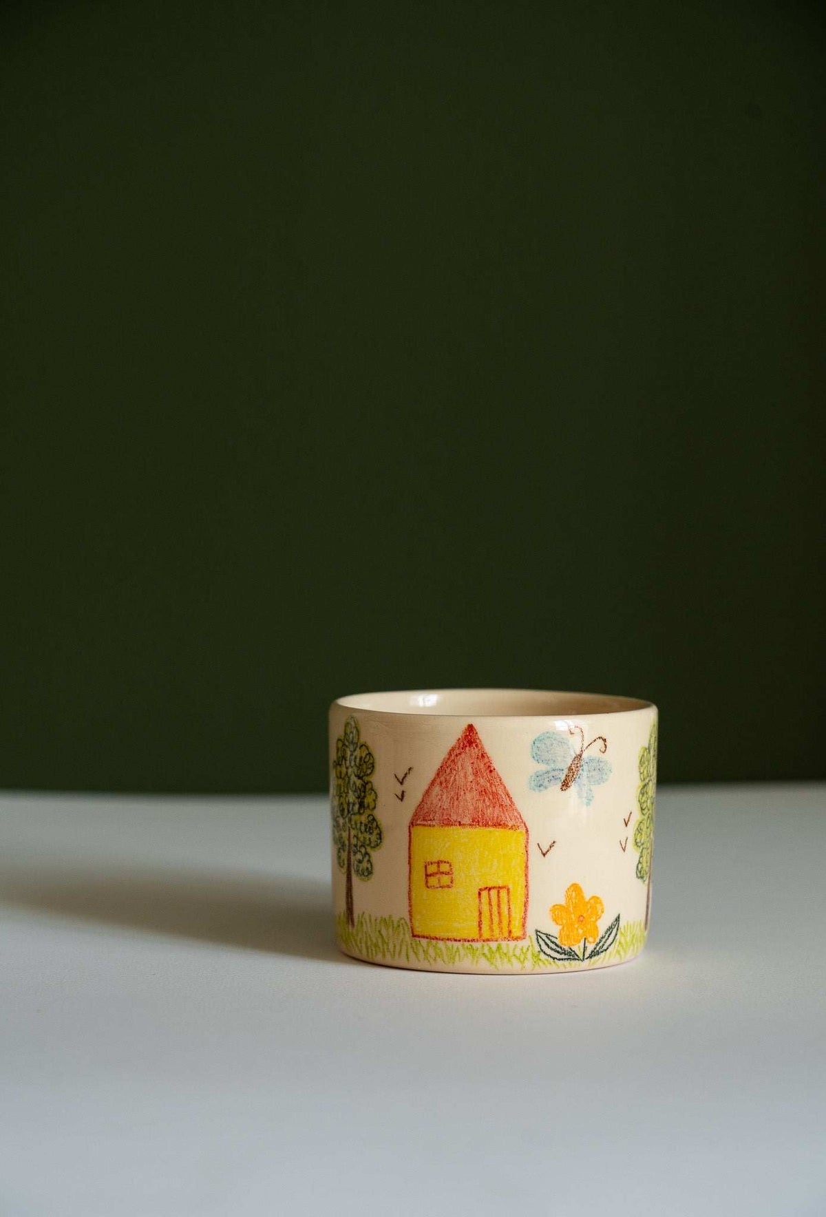 Kids Artwork Stoneware Mug in beige ceramic, decorated with colorful hand-drawn house, trees, flowers, sun and birds.