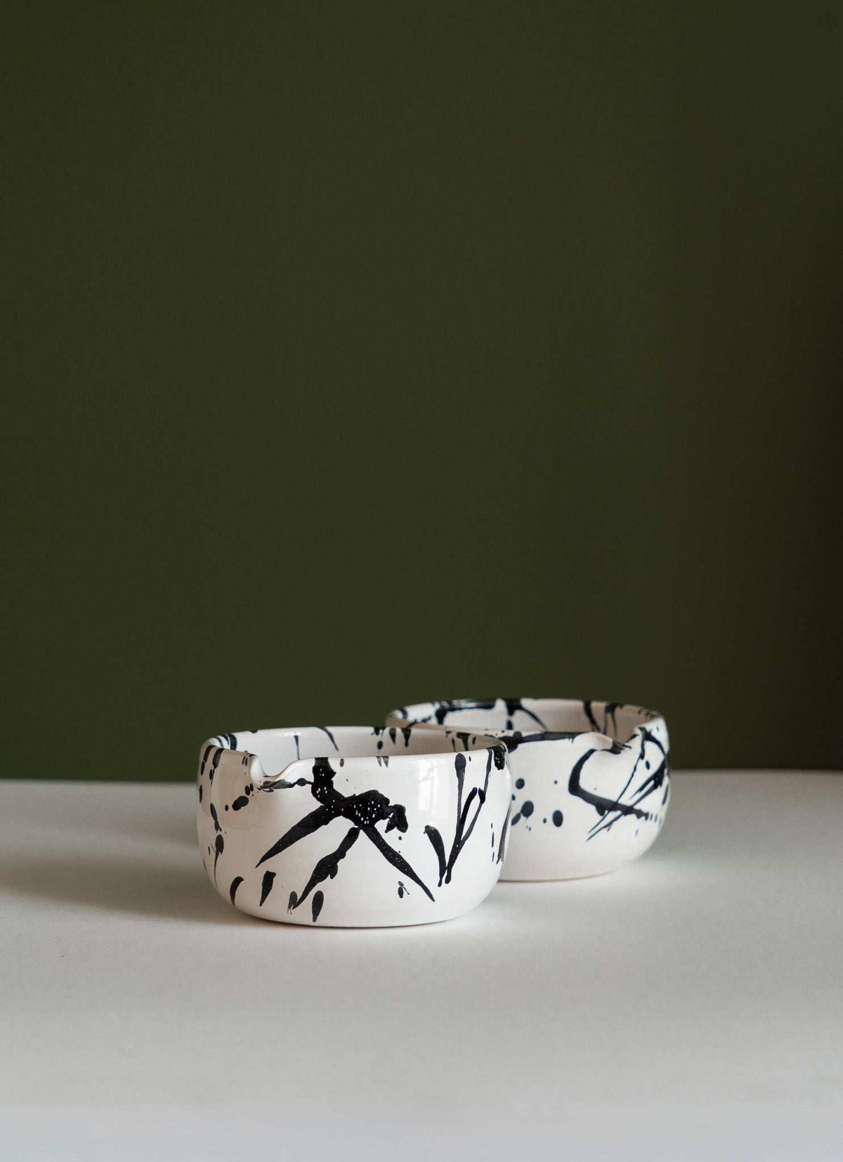 Handmade Matcha Bowl in white glazed stoneware, with bold black splatter strokes and an irregular handmade rim.