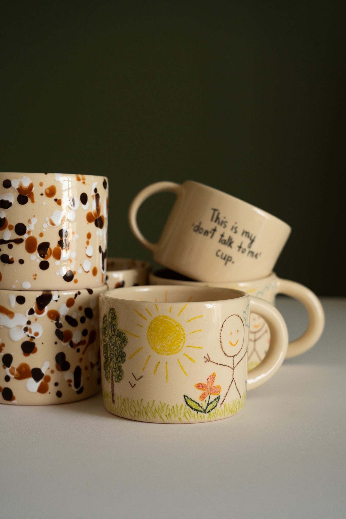 Personalized Stoneware Mug with a glossy beige ceramic finish, featuring colorful hand-drawn sun, flowers, and figures.