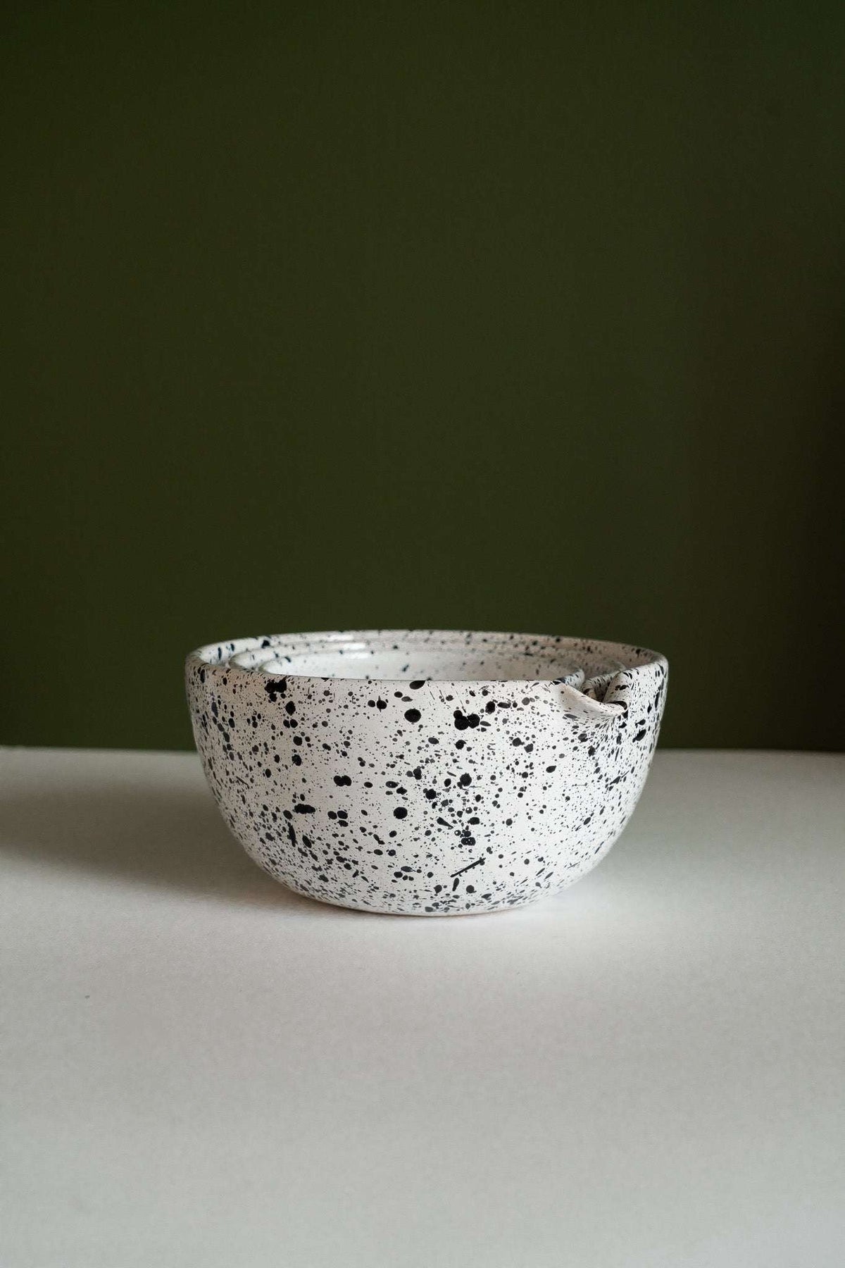 Deep stoneware mixing and serving bowls with pour spouts and artisanal speckled finish nesting for storage