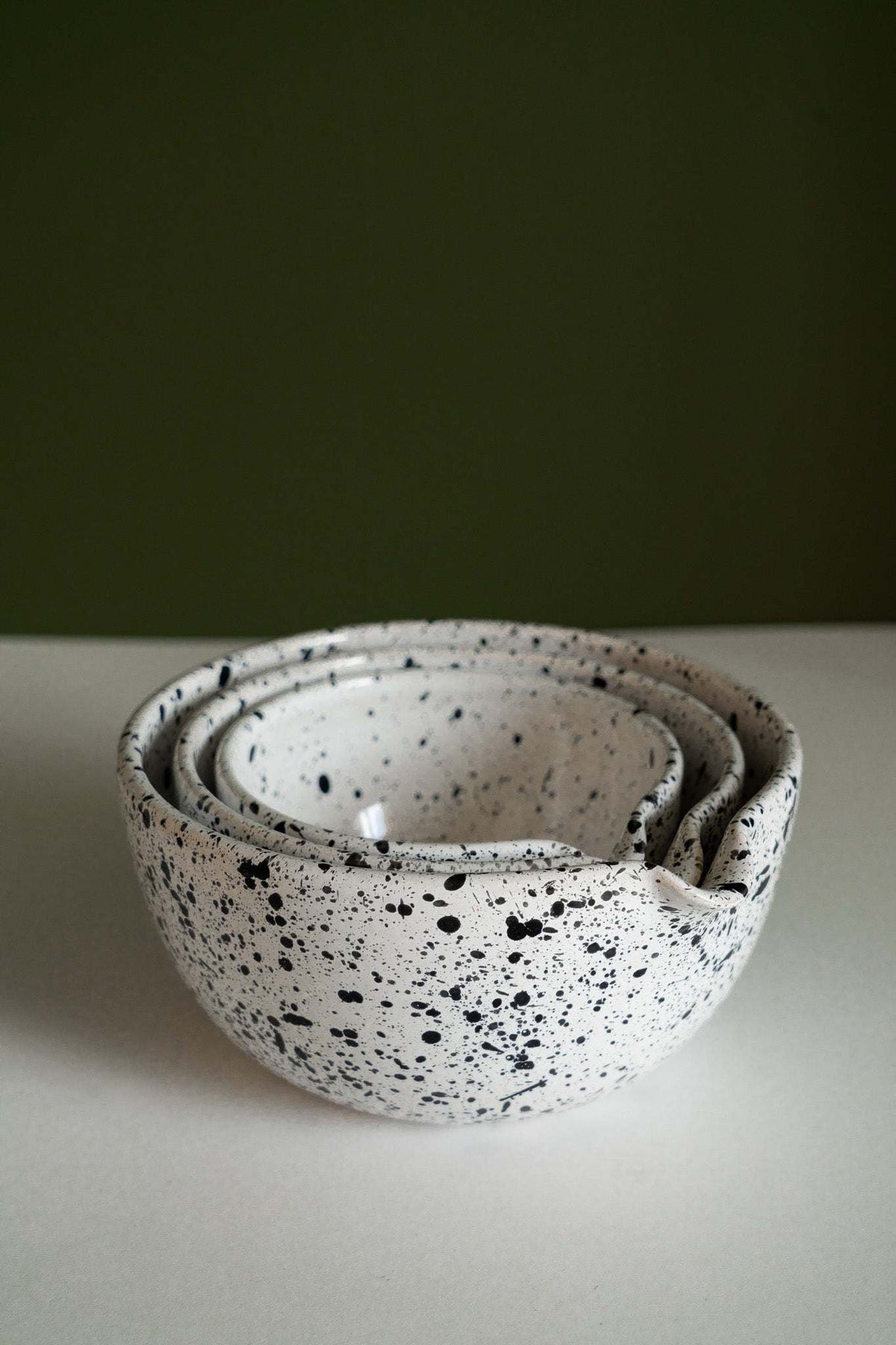 Set of deep stoneware mixing and serving nesting bowls with pour spouts and speckled artisanal finish