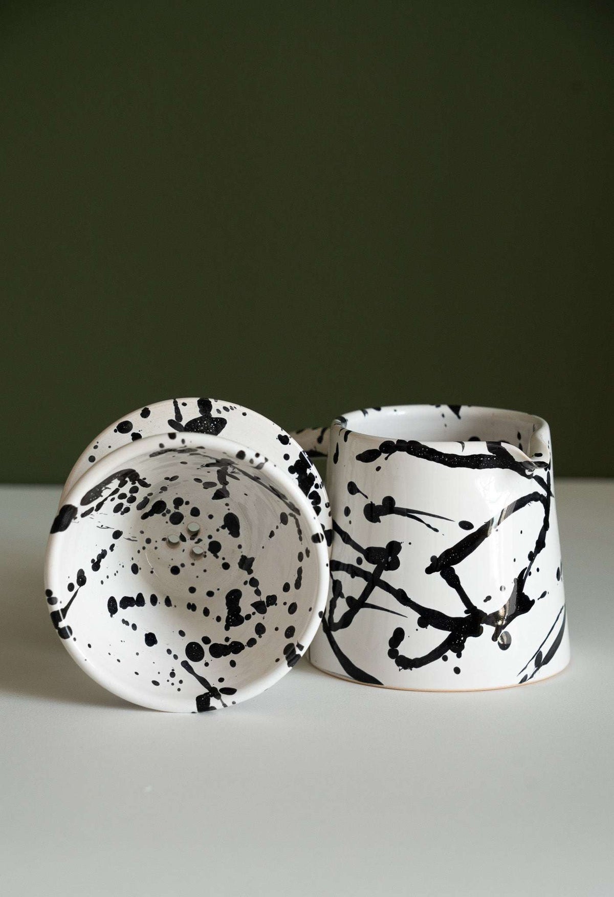 Handmade ceramic pour-over coffee dripper and pitcher set in black and white stoneware