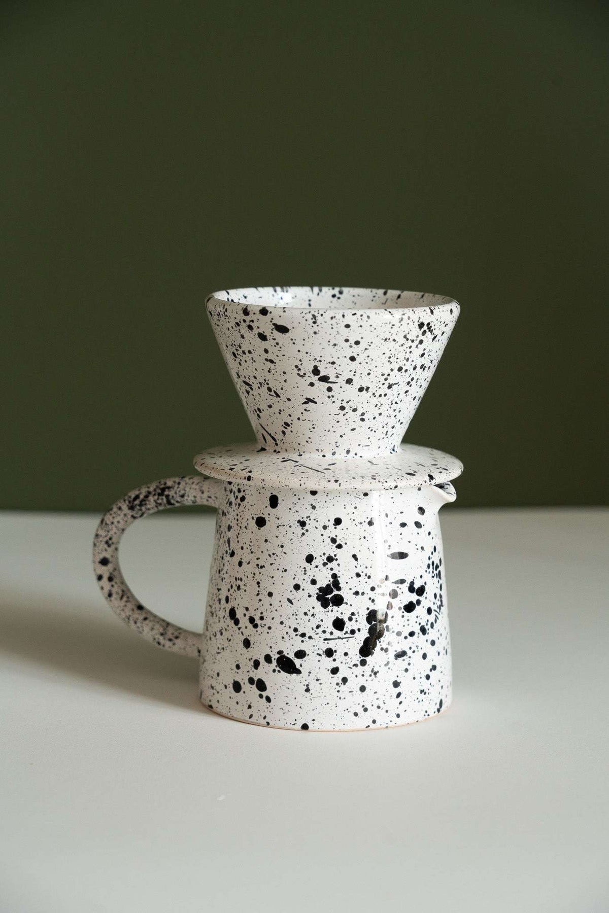 Handmade ceramic pour over coffee set with stoneware dripper and matching pitcher in monochrome design