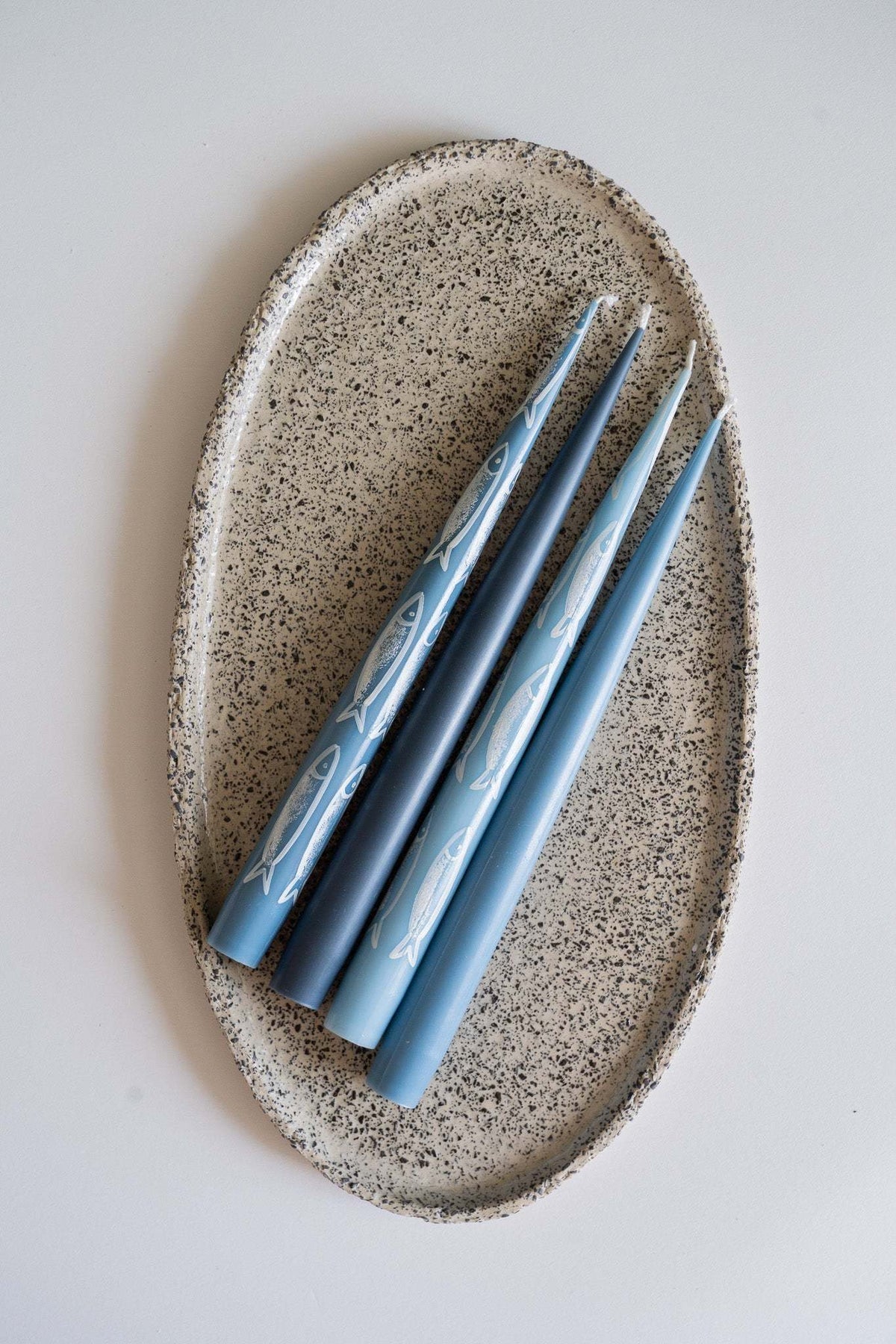 Hand-painted taper candle set with blue sardine illustrations in coastal nautical style