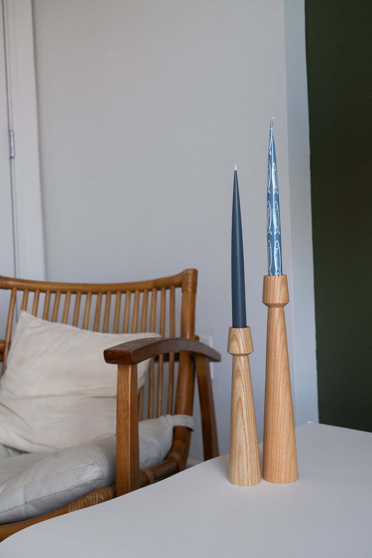 Hand-painted taper candle set featuring sardine illustrations in blue ocean tones for coastal decor
