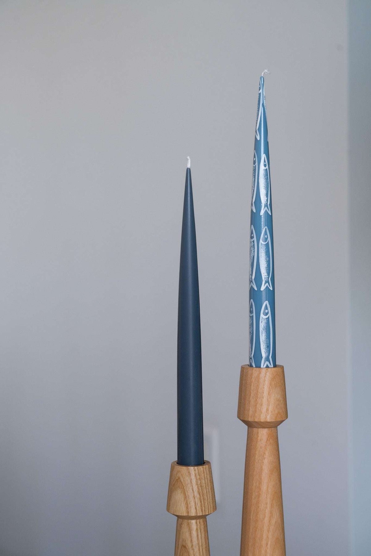 Hand-painted taper candle set with blue sardine illustrations for coastal decor and seafood dinners