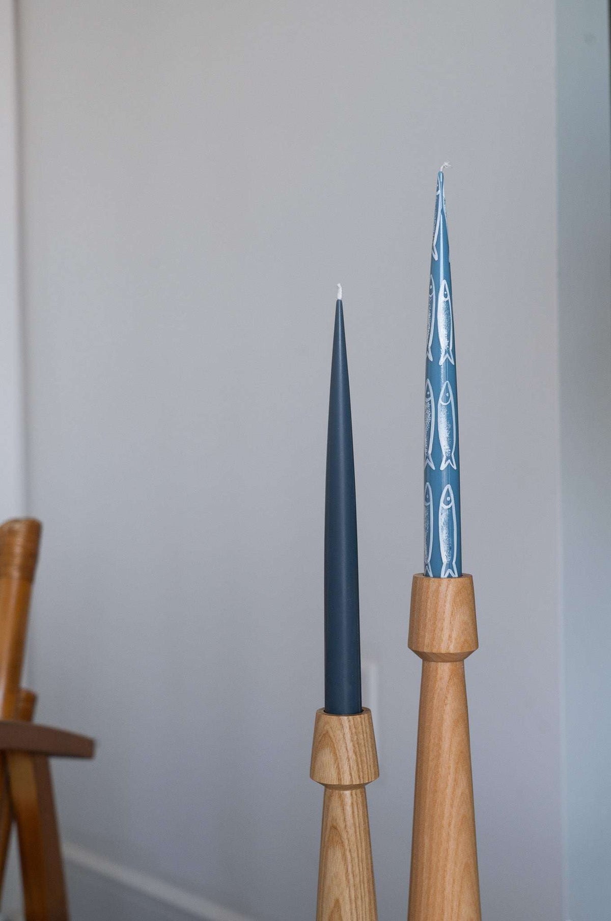 Set of four hand-painted taper candles with sardine illustrations in blue ocean tones for coastal decor