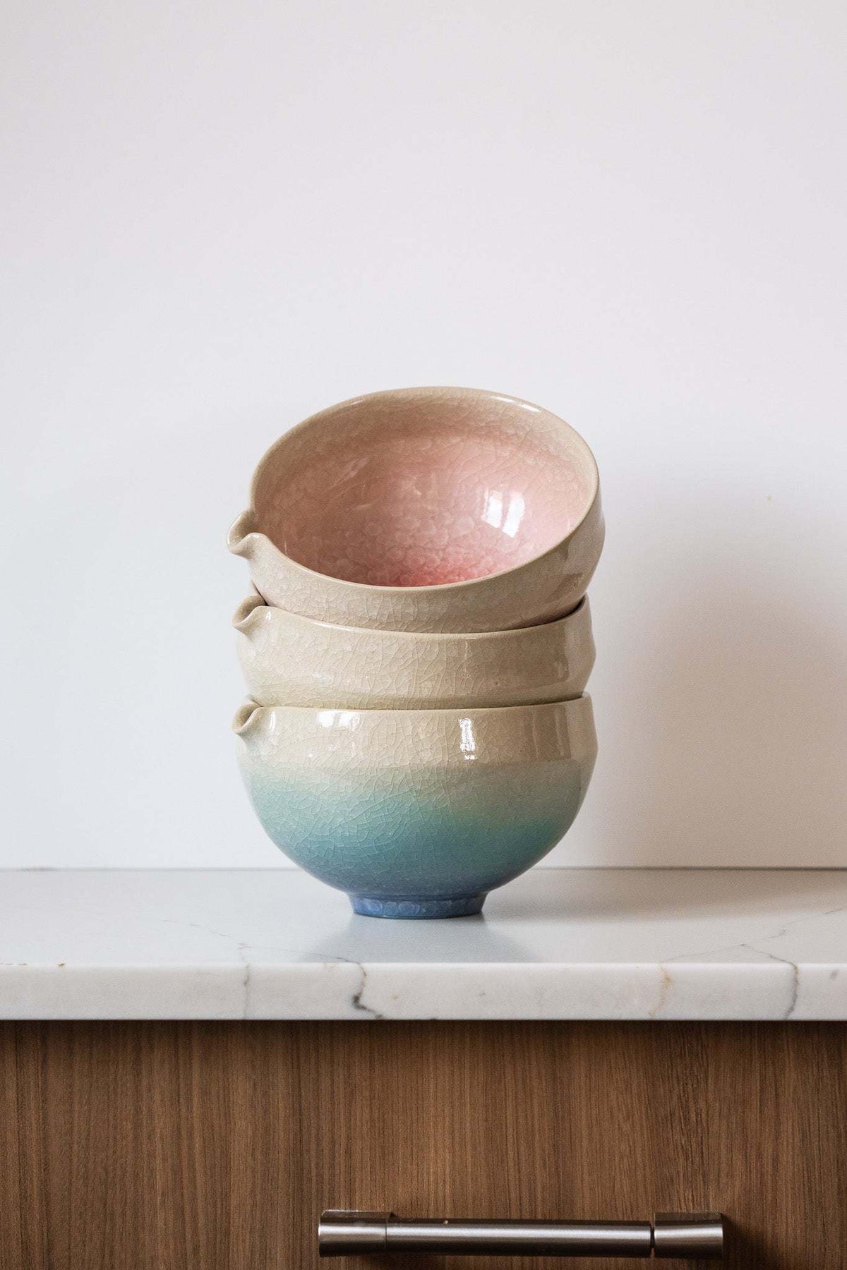 Ceramic Matcha Bowl set of three nested stoneware bowls, with sandy cream rims and blush pink, ivory, and blue-green glaze gradients.