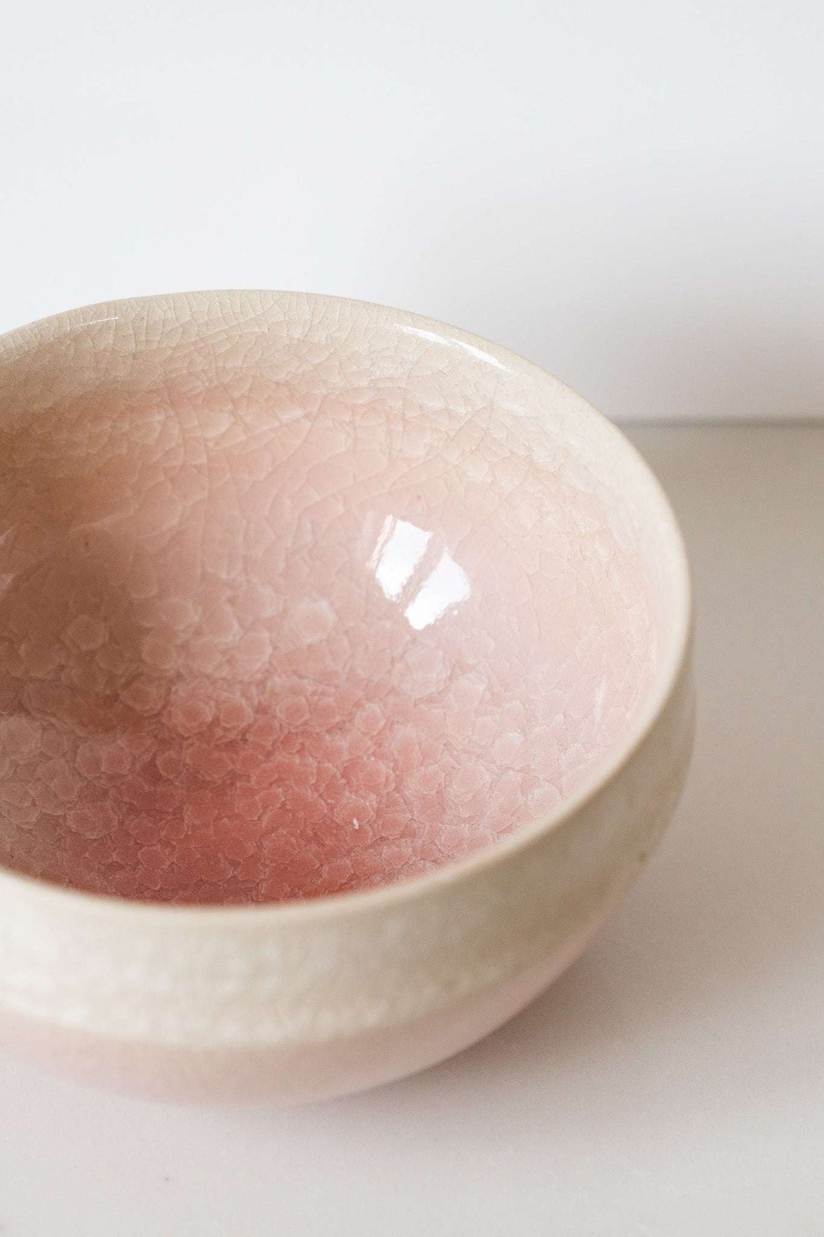 Ceramic Matcha Bowl in pale blush pink stoneware with a glossy crackle glaze and softly rounded shape.