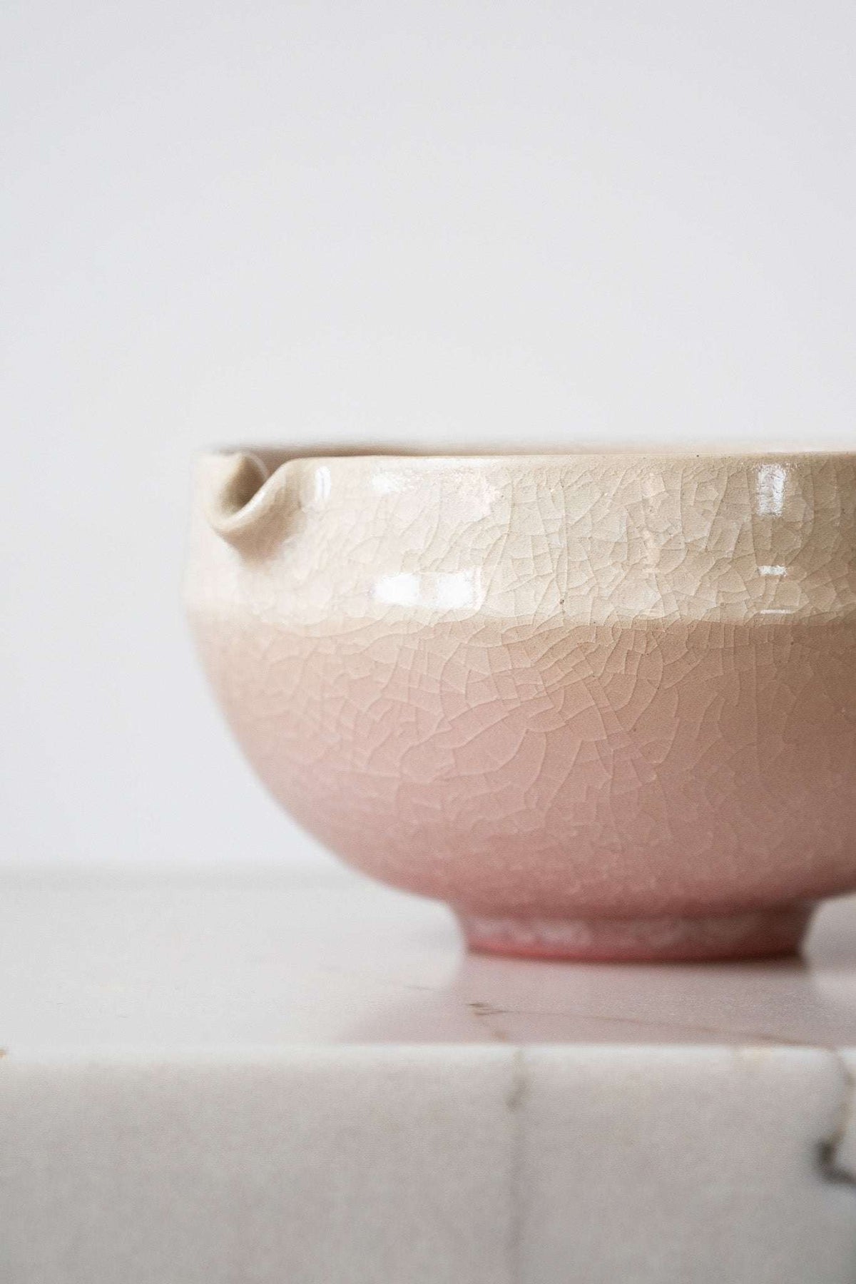 Ceramic Matcha Bowl in blush pink and sandy cream stoneware, with a delicate crackle glaze and built-in spout