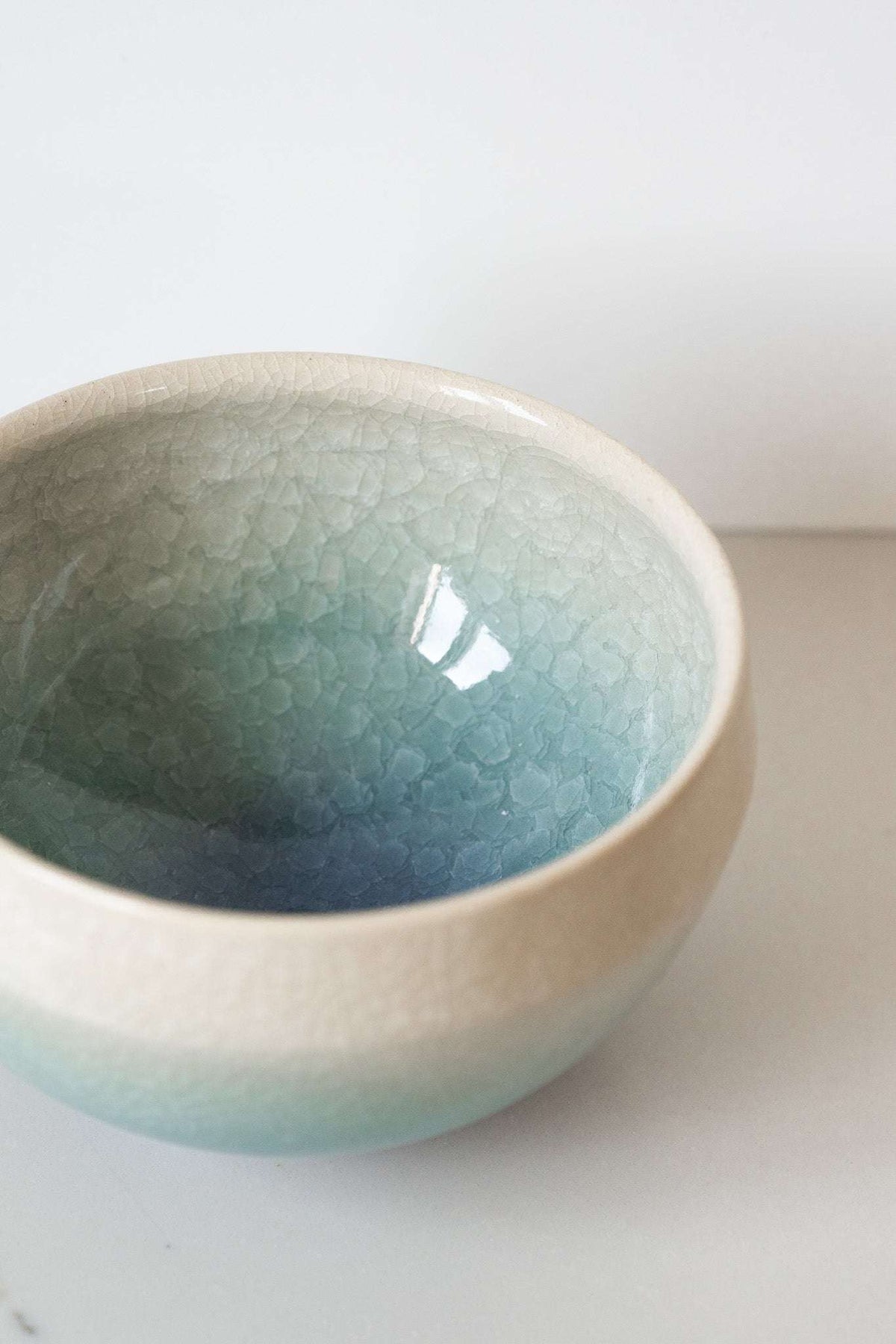 Ceramic Matcha Bowl in stoneware with a pale cream-to-blue gradient glaze and delicate crackle texture.