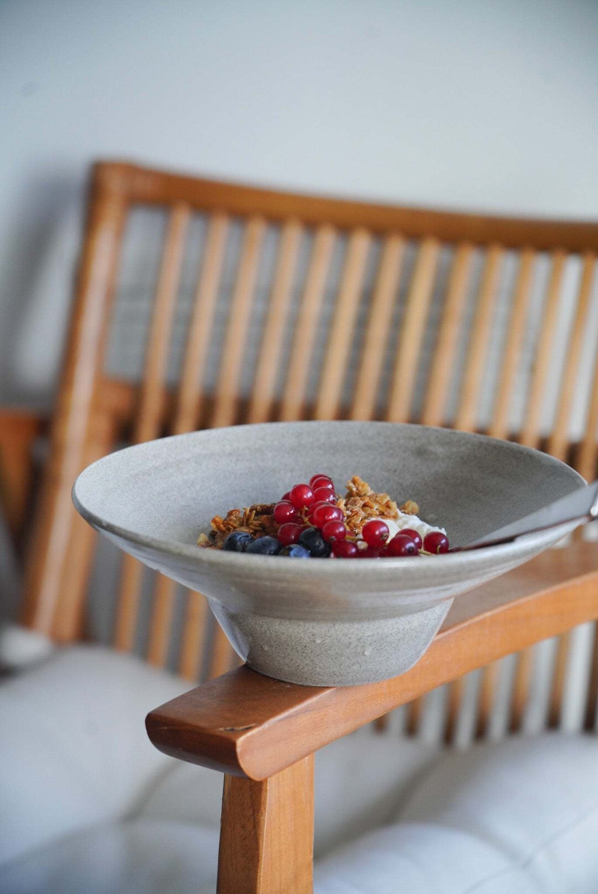 Handmade Stoneware straw hat plate in grey concrete-textured glaze, with a wide rim and deep central bowl.