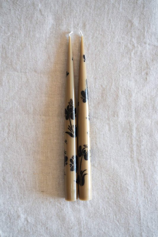 Hand-Painted Taper Candle Set in warm beige, with slender wax candles decorated in hand-painted black floral motifs.