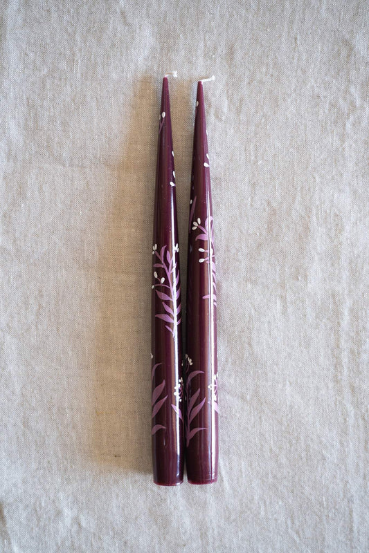 Hand-Painted Taper Candle Set of two burgundy wax candles with delicate pale pink hand-painted floral branches and white accents.
