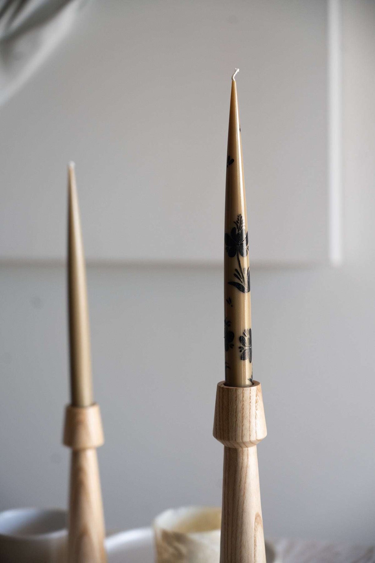 Hand-Painted Taper Candle Set in warm brown, with slender wax candles and delicate dark botanical motifs.