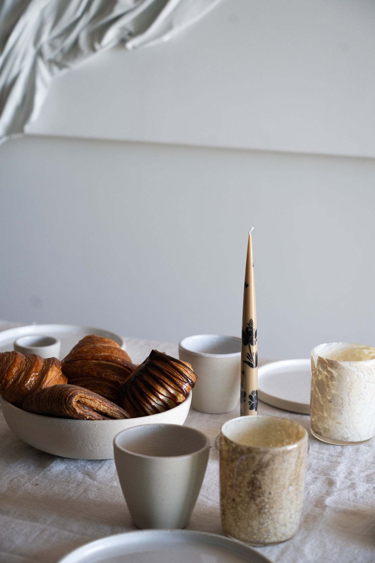 Hand-Painted Taper Candle Set in warm brown with delicate black hand-painted markings, slender tapered shape and a white wick.