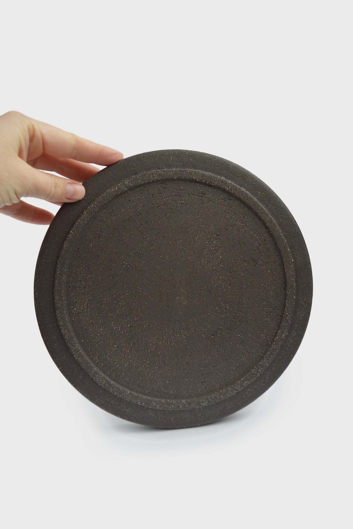 Handmade stoneware dinner plates in pumpernickel color with smooth glaze and rough exterior