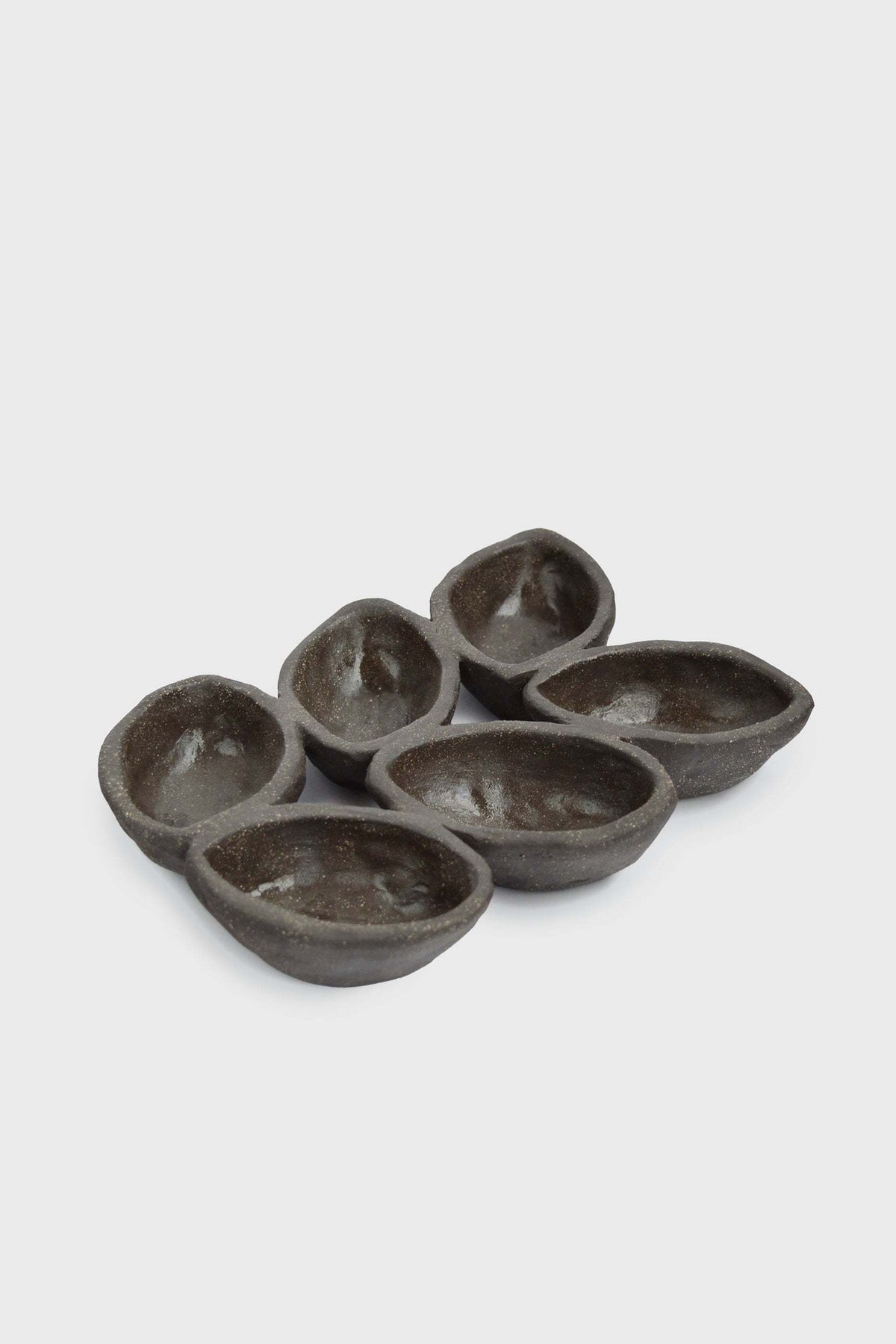 Stoneware Serving Dish in deep earthy brown-gray, with a glazed interior and six connected serving wells.