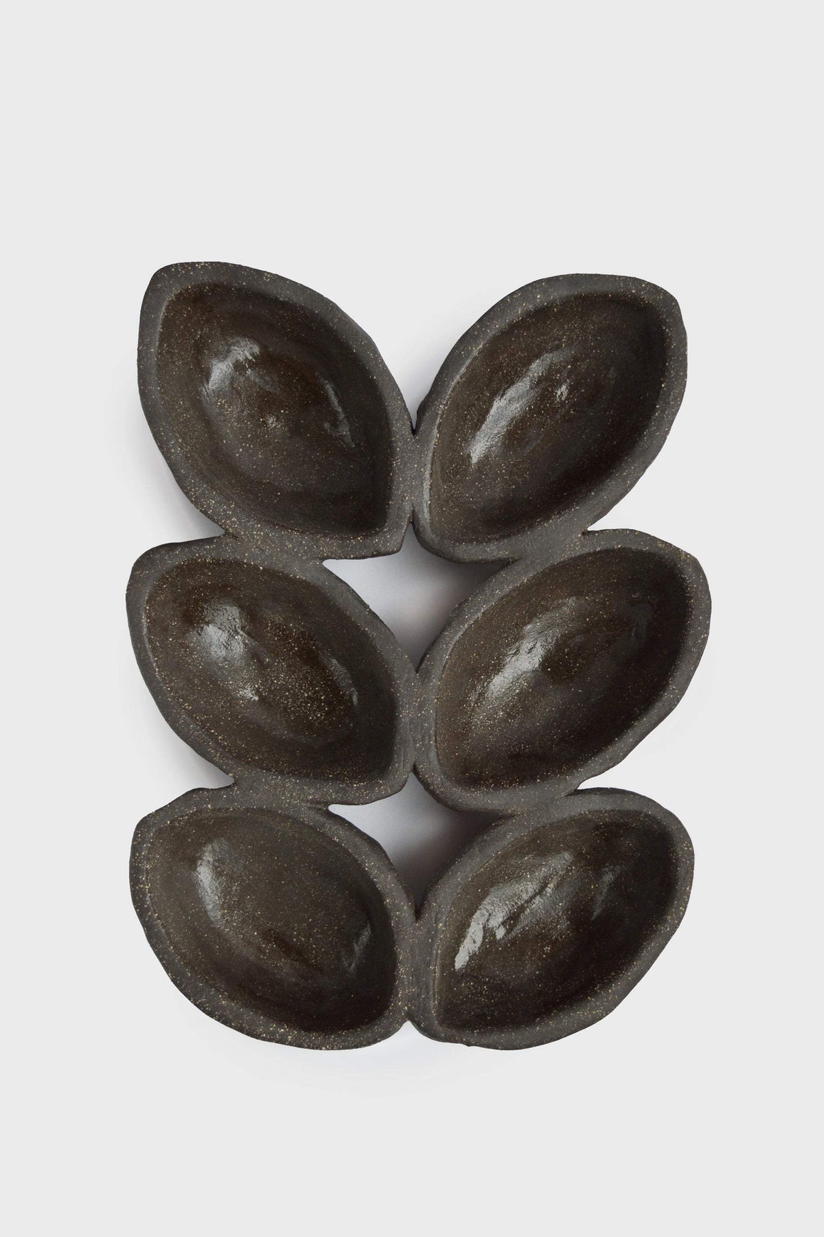 Stoneware Serving Dish in deep earthy brown with a glazed interior, raw-textured exterior, and six oval wells arranged in pairs.