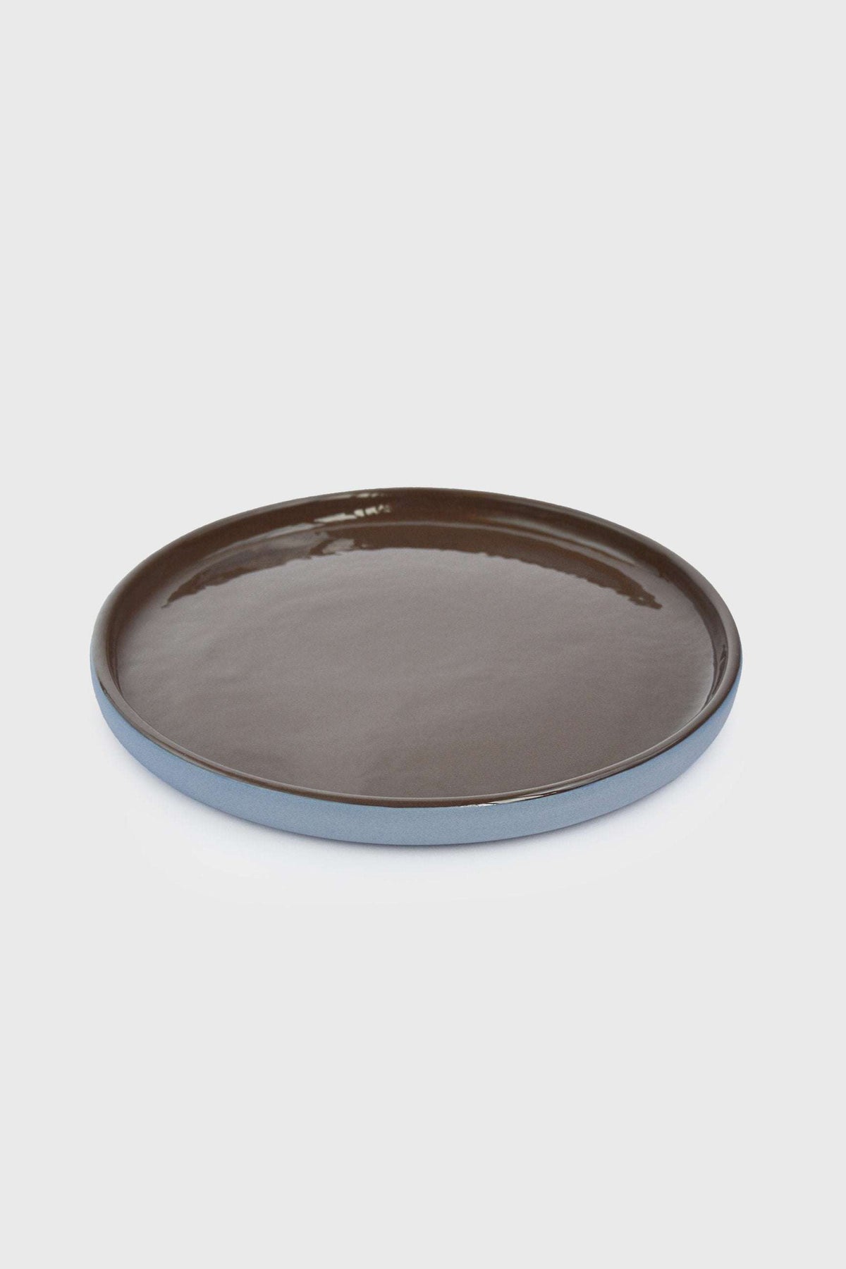 Handmade Blue Porcelain dinner plate with a glossy chocolate-brown glazed center and pale blue exterior rim.