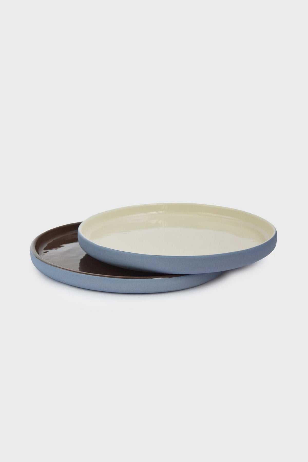 Handmade Blue Porcelain plates with blue exteriors, one cream-glazed and one chocolate-brown, in a mix-and-match set.