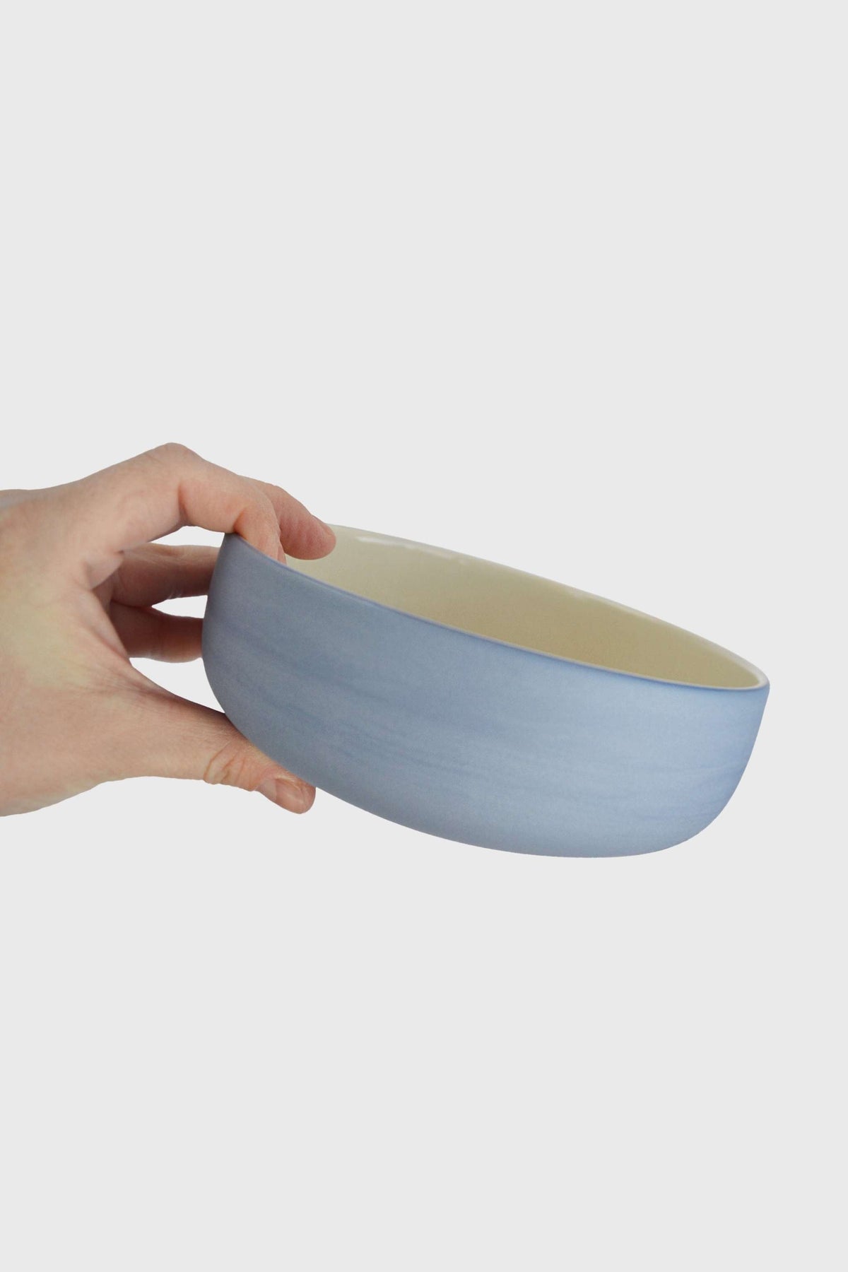 Handmade porcelain bowl with forget-me-not exterior and chocolate brown interior glaze