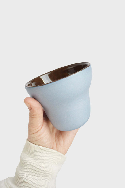 Handmade pear-shaped porcelain coffee cup with forget-me-not exterior and chocolate interior glaze