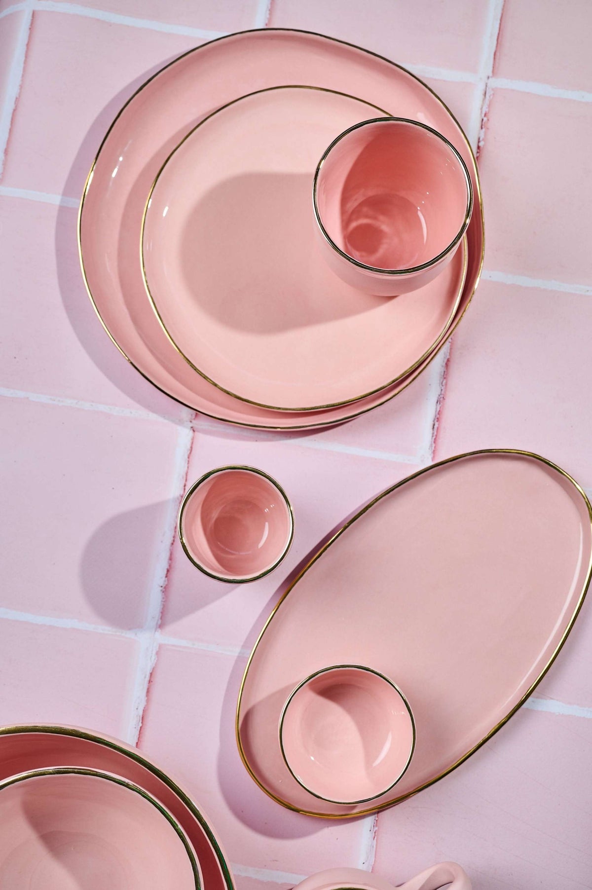 Handmade porcelain dinner plates in powder pink with gold rim and shiny glaze