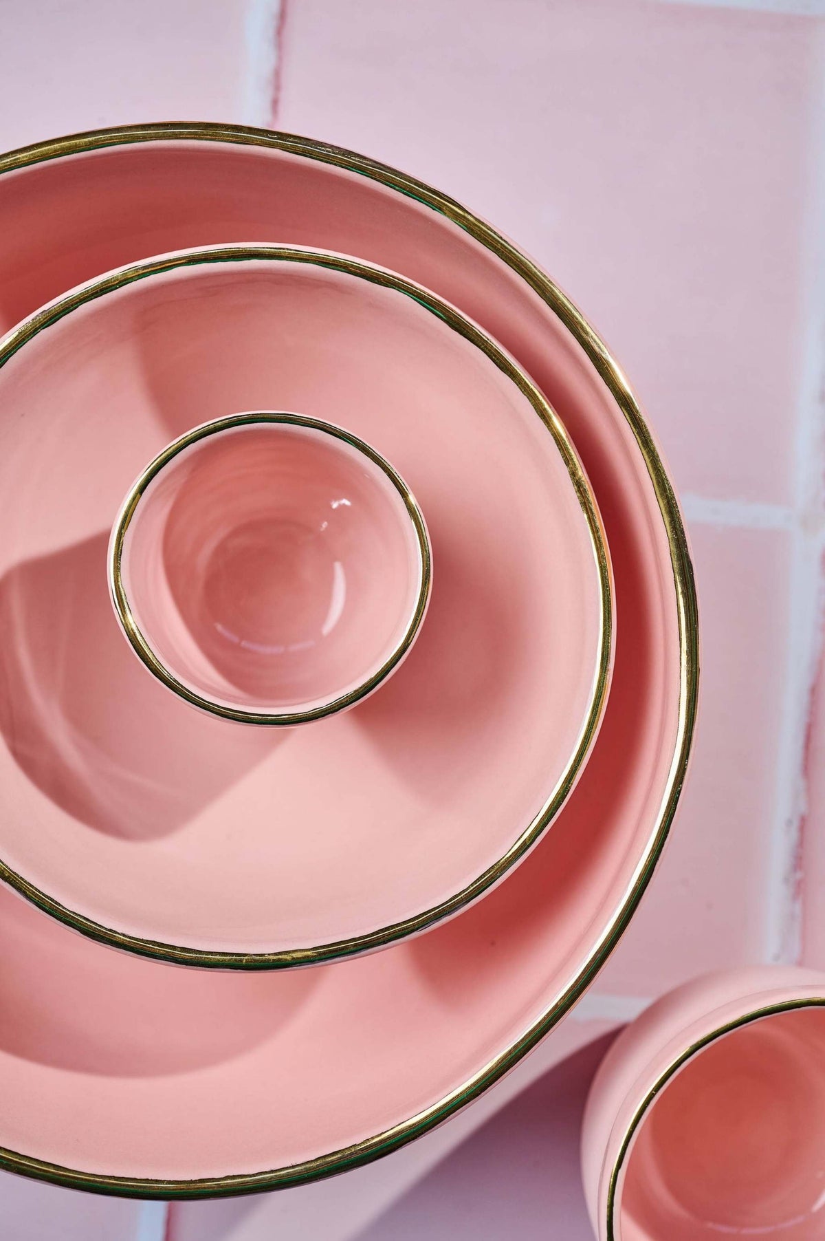 Handmade porcelain bowl in powder pink with gold rim, glossy interior and smooth exterior