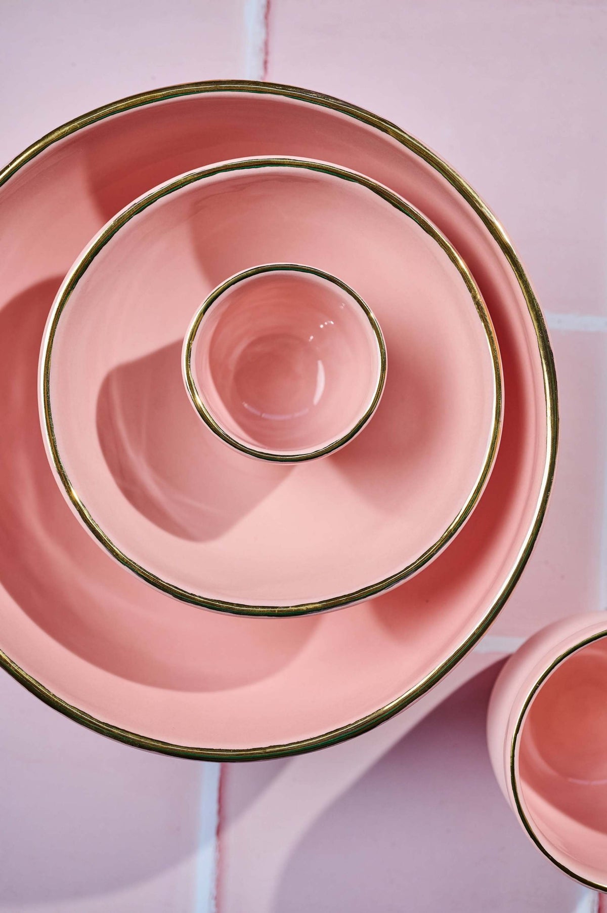 Handmade porcelain espresso cup in powder pink with gold rim and exposed clay exterior