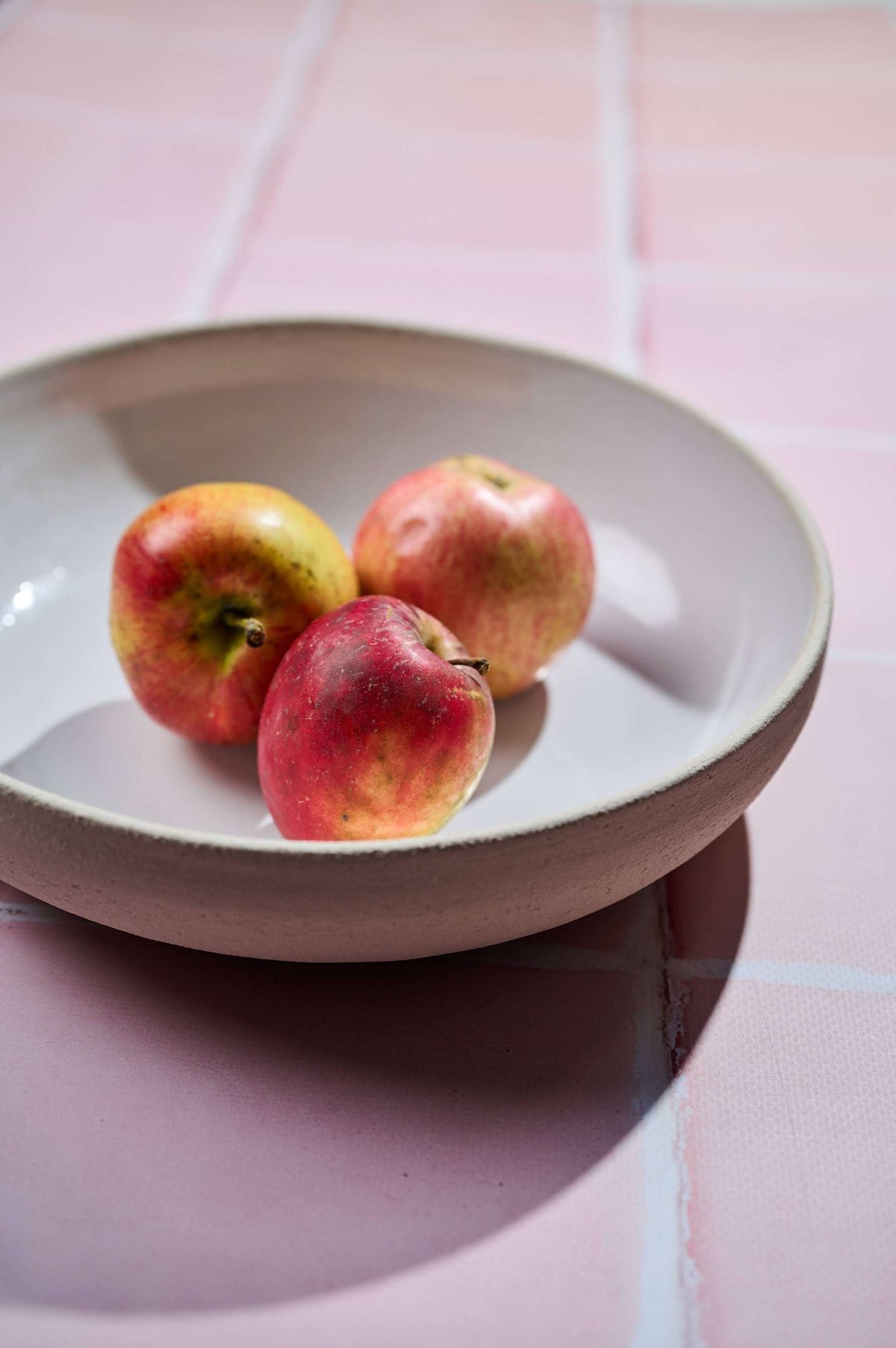 Stoneware Pasta Bowl in matte taupe stoneware, with a smooth white interior and gently irregular handmade rim.