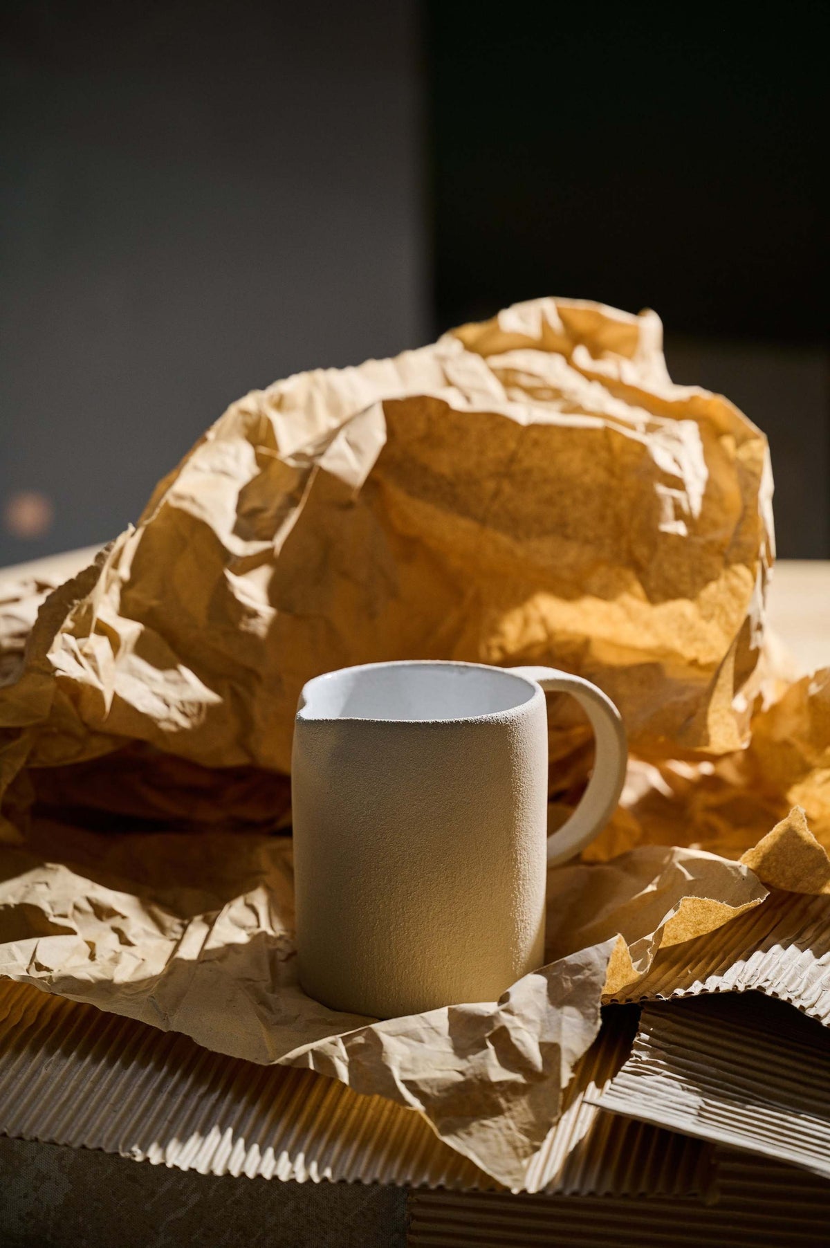 Handmade stoneware pitcher with white glazed interior and rustic exterior, crafted in Ukraine