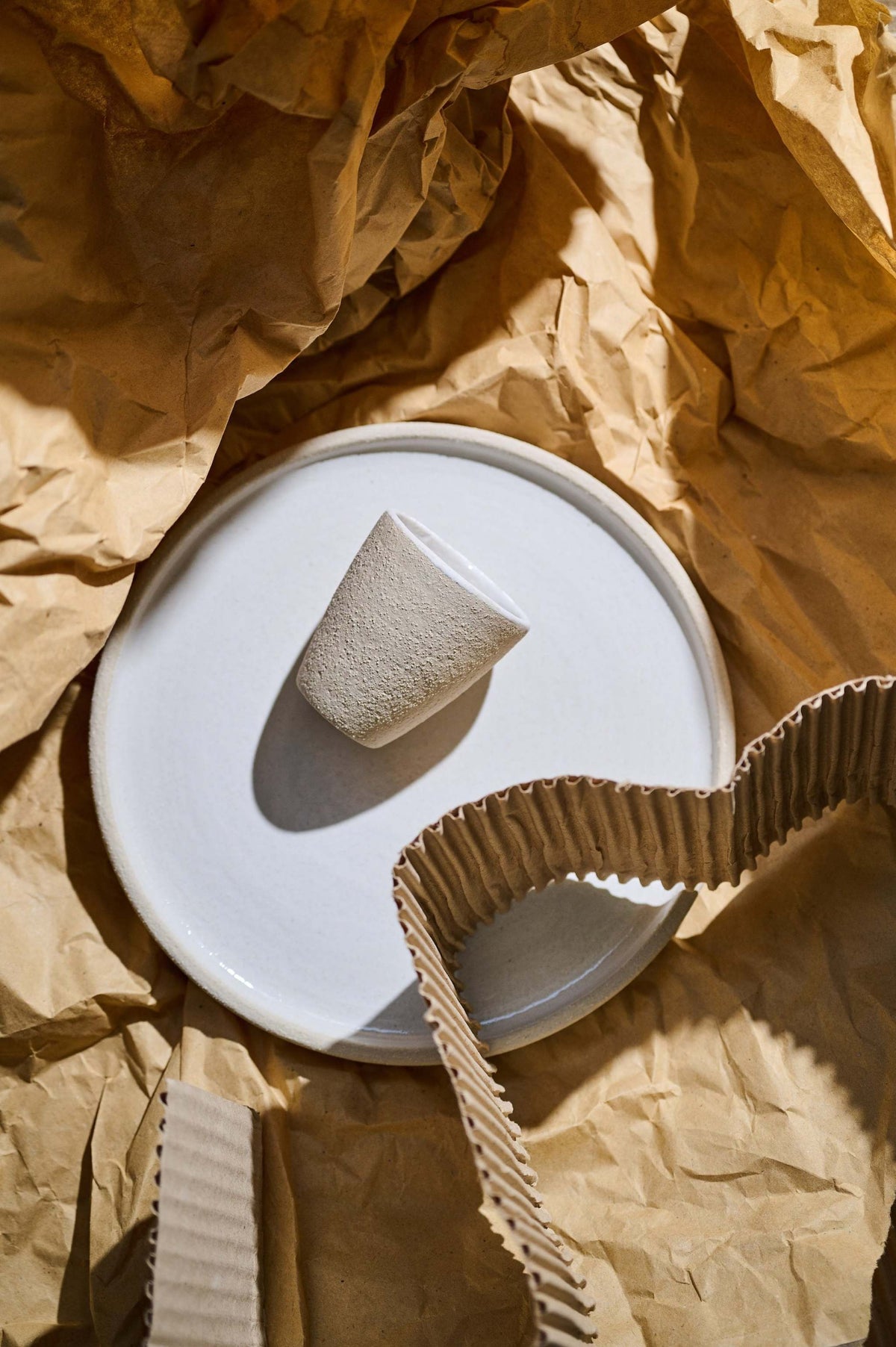 Handmade stoneware espresso cup with exposed clay exterior and white glazed interior, dishwasher safe, made in Ukraine