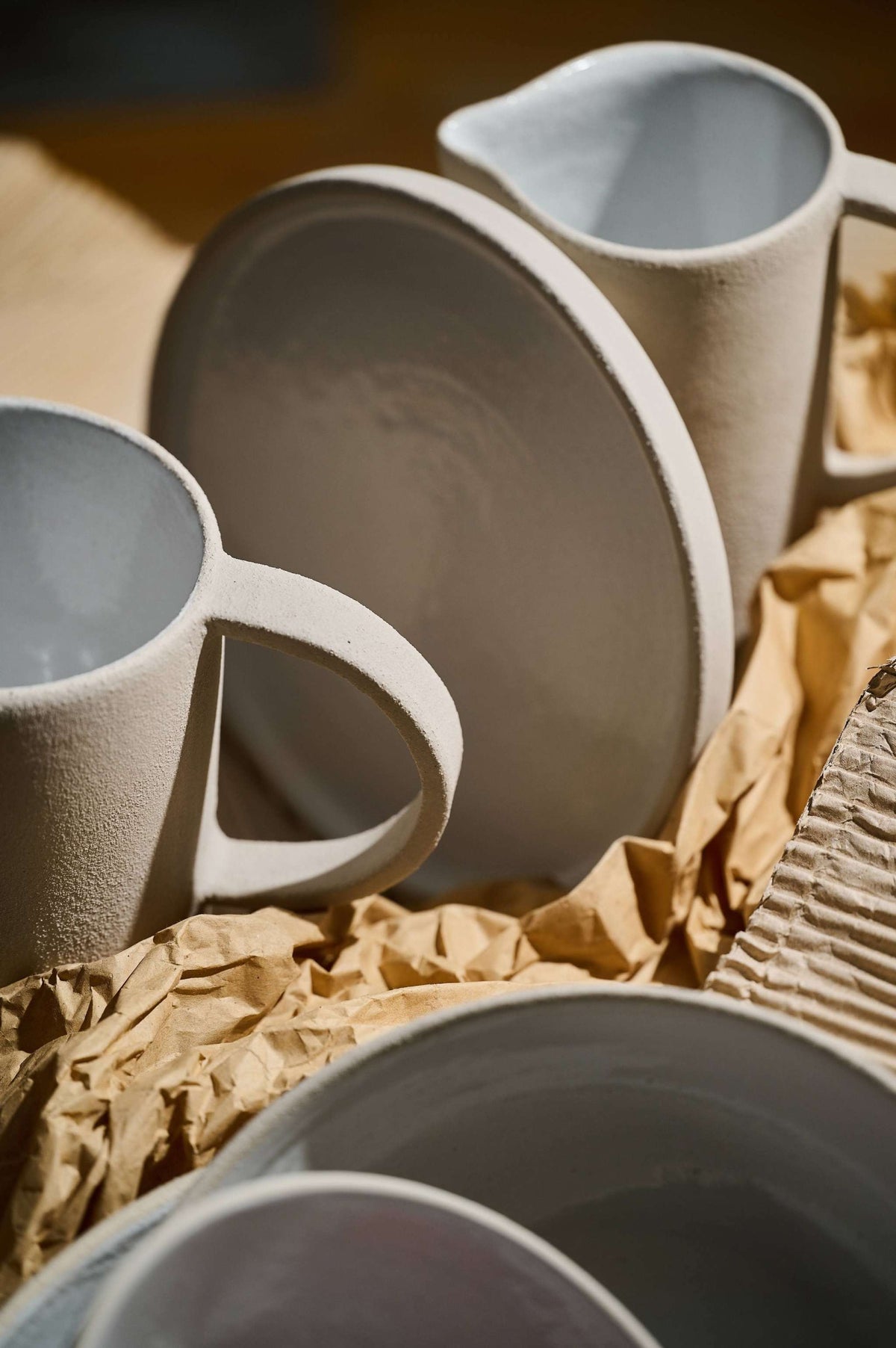 Handmade stoneware large pitcher with rough texture and white glazed interior