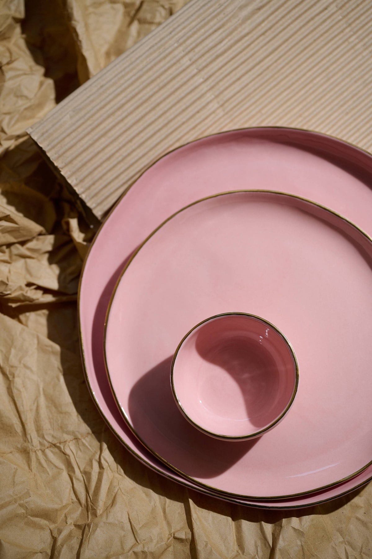 Handmade porcelain dinner plates in powder pink with gold rim and shiny glaze