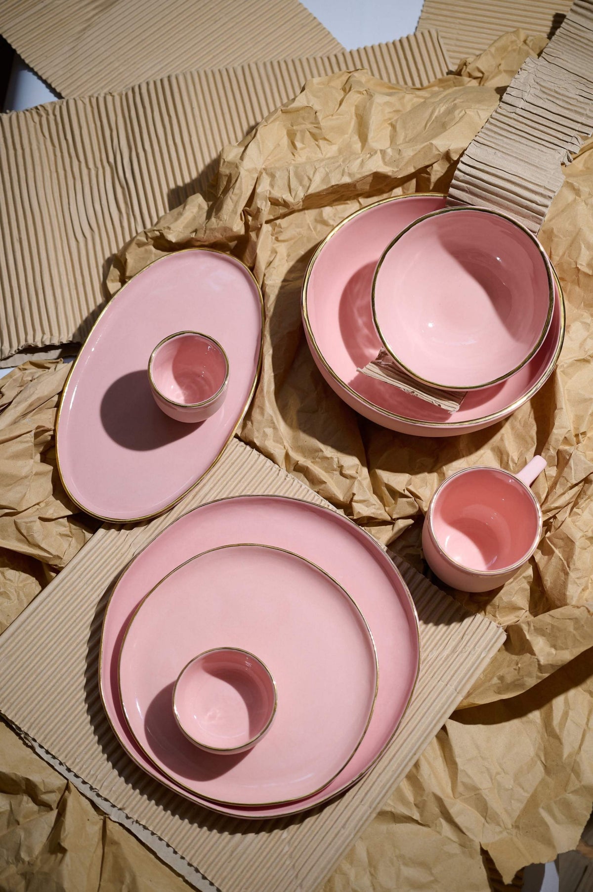 Handmade porcelain coffee mug in powder pink with gold rim and glossy finish