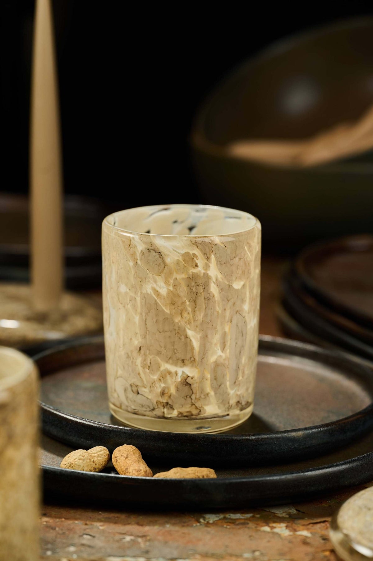 Hand blown glass tumbler with marble-inspired pattern and unique shape made in Ukraine