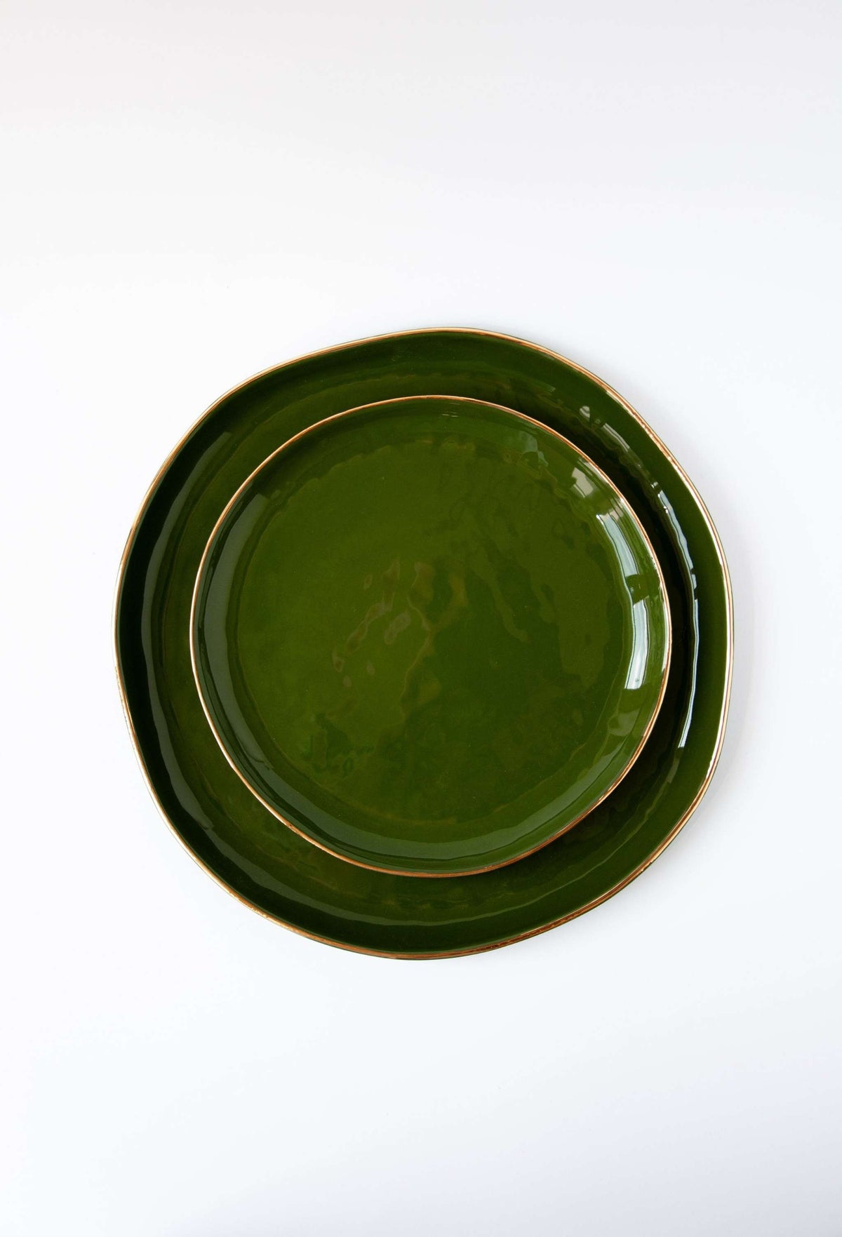 Handmade porcelain dinner plate with gold rim and green background