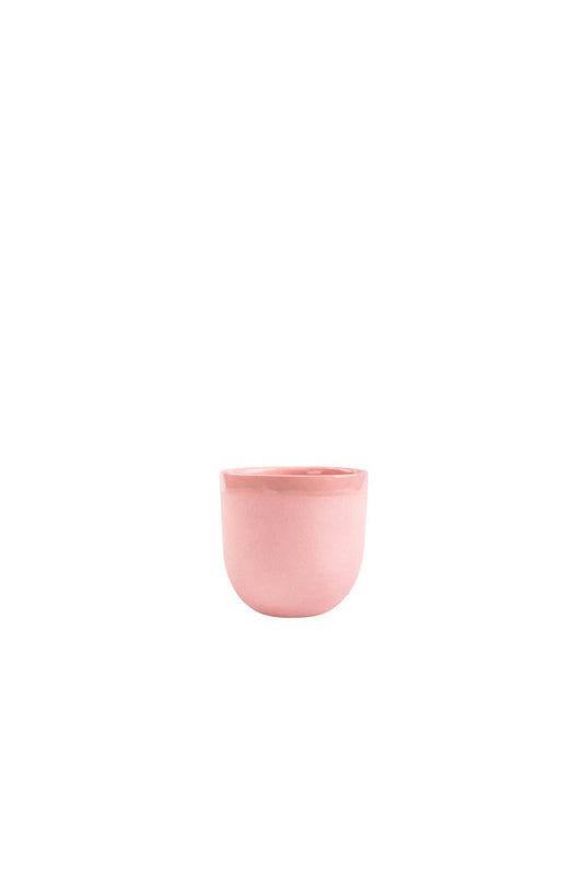Handmade porcelain espresso cup in powder pink with smooth glaze and exposed clay exterior