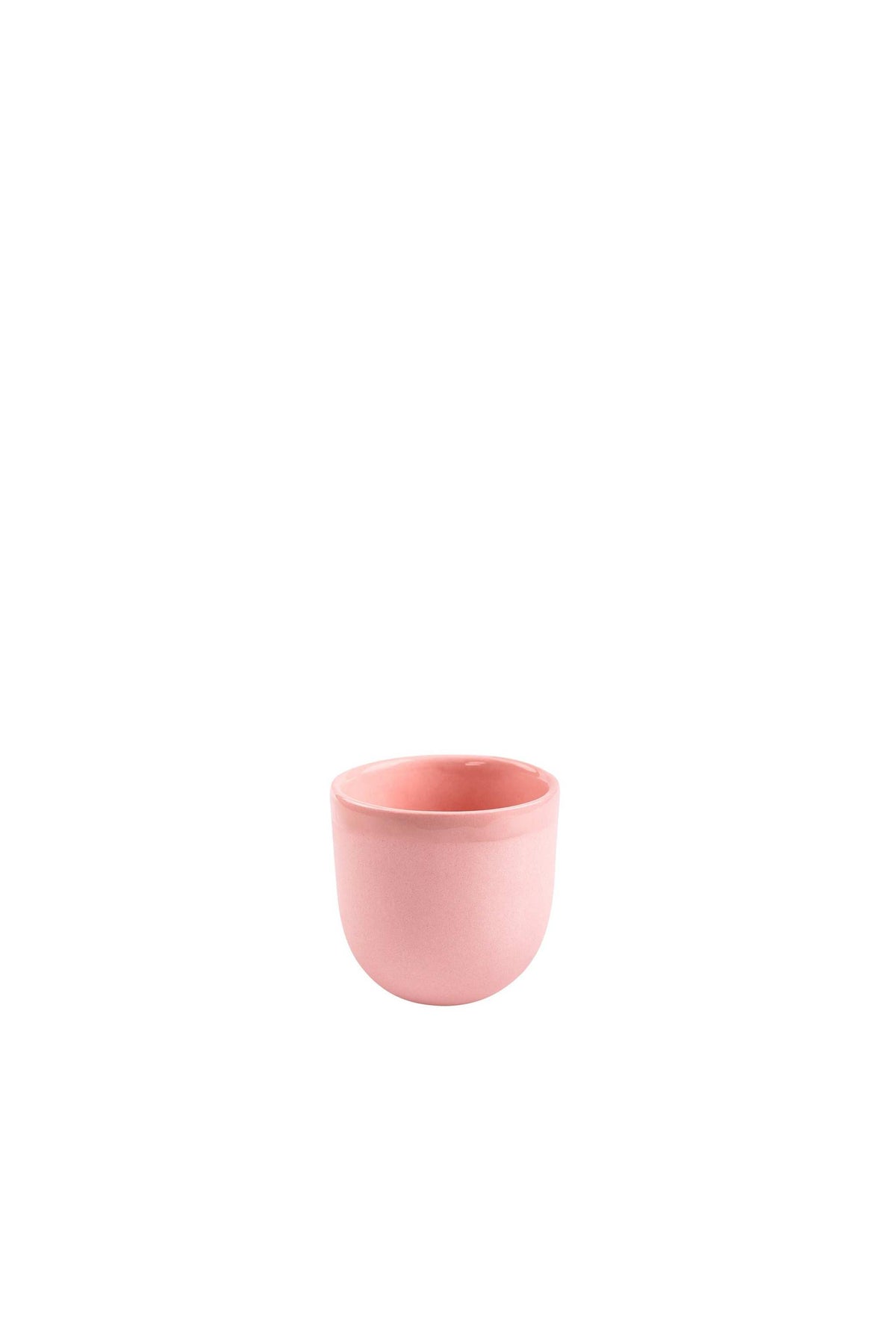 Handmade porcelain espresso cup in powder pink with exposed clay exterior and shiny glazed interior.