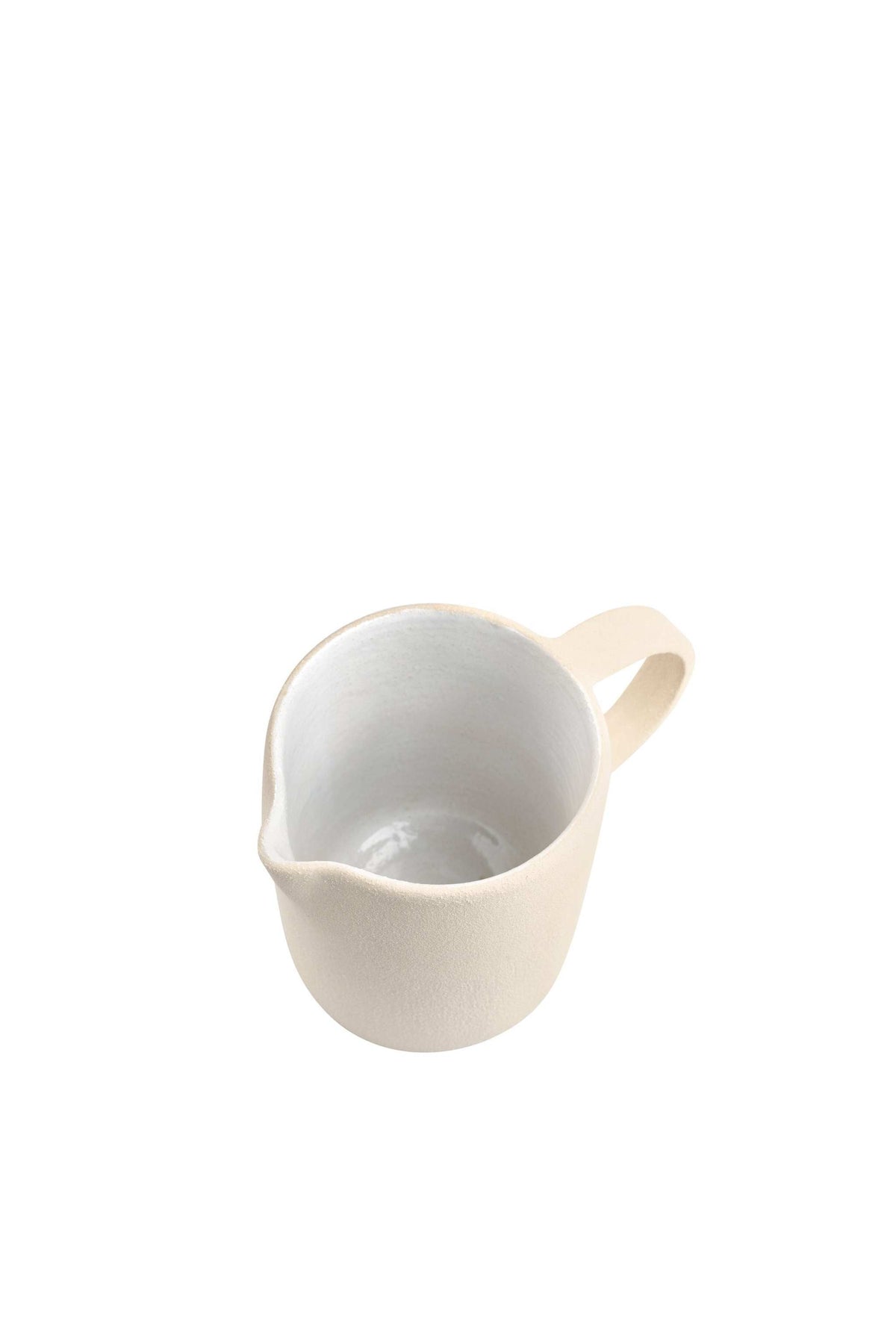 Handmade stoneware pitcher with rough texture and white glazed interior, crafted in Ukraine