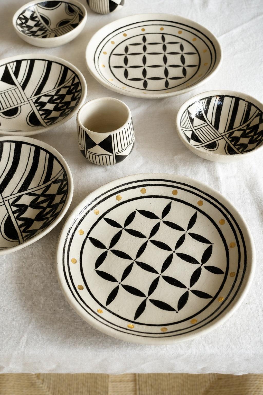 Hand Painted Stoneware Salad Plate in cream with bold black geometric motifs, fine gold dots, and a glossy glaze.