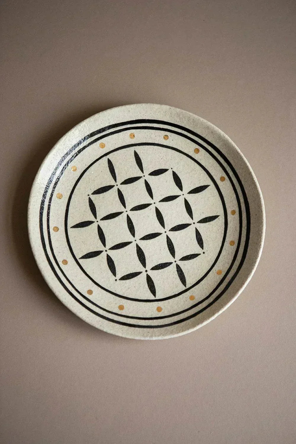 Hand Painted Stoneware Dinner Plate in cream ceramic, with a black geometric floral pattern and small ochre dots.