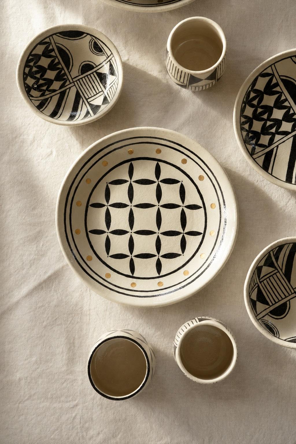Hand Painted Stoneware Salad Plate with a cream glossy surface, black geometric motifs and small ochre accents.