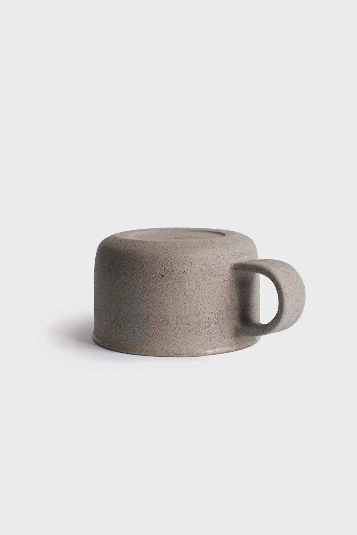 Handmade Stoneware Coffee Mug in speckled gray stoneware, with a low, wide shape and rounded handle.
