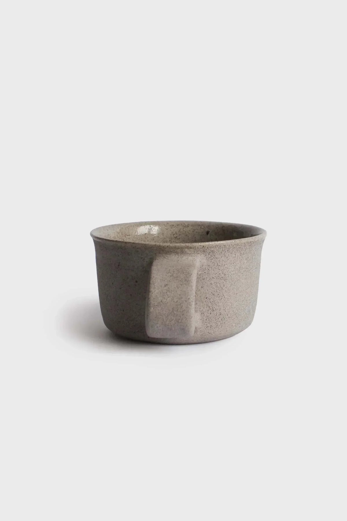 Handmade Stoneware Coffee Mug in mottled gray-brown glaze, with a wide open shape and no visible handle.