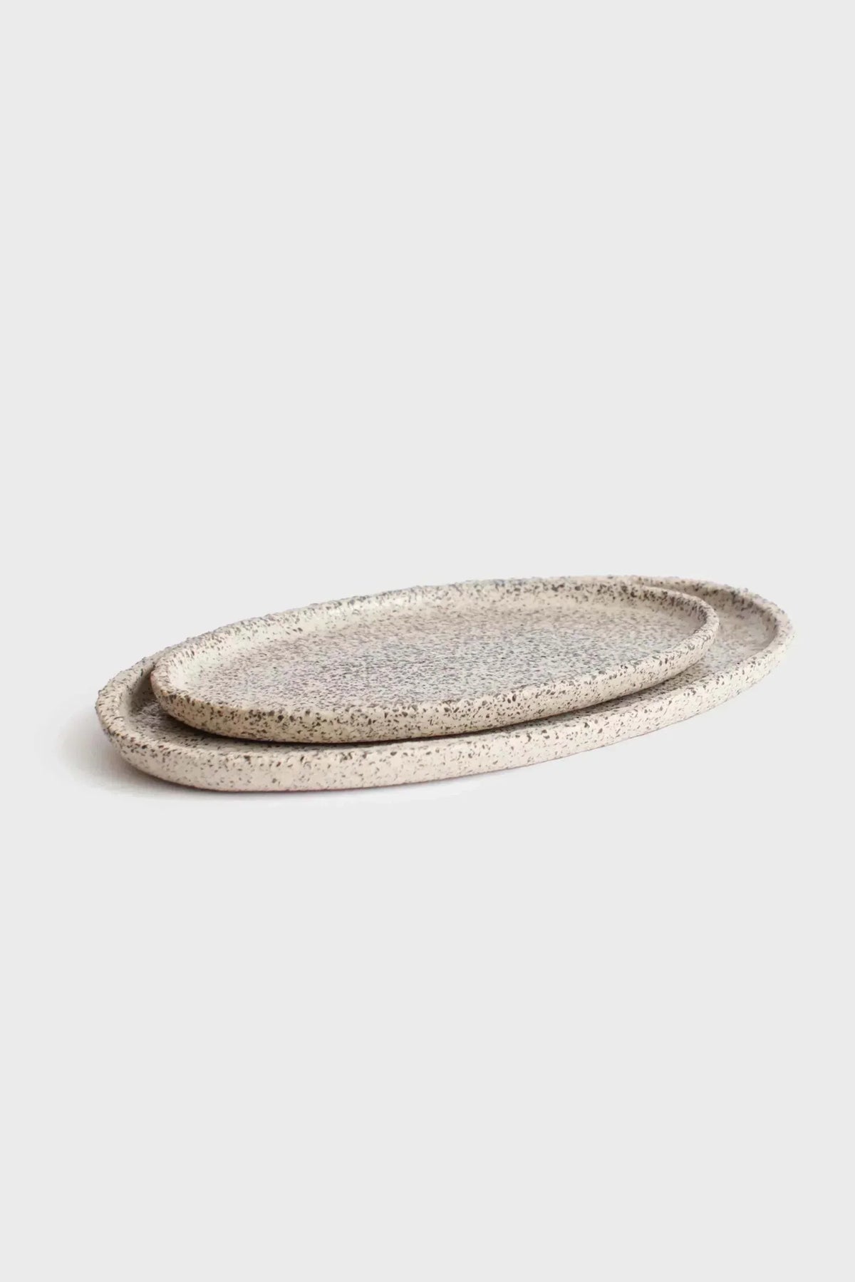 Large Serving Platter in creamy white speckled stoneware, with an organic oval shape and raised rim.