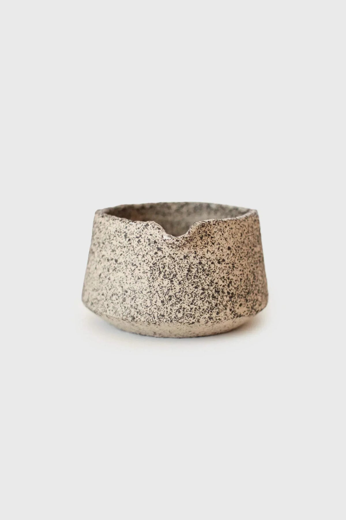 Handmade Stoneware Matcha Bowl in creamy white with dense black speckles and an irregular, hand-formed rim.