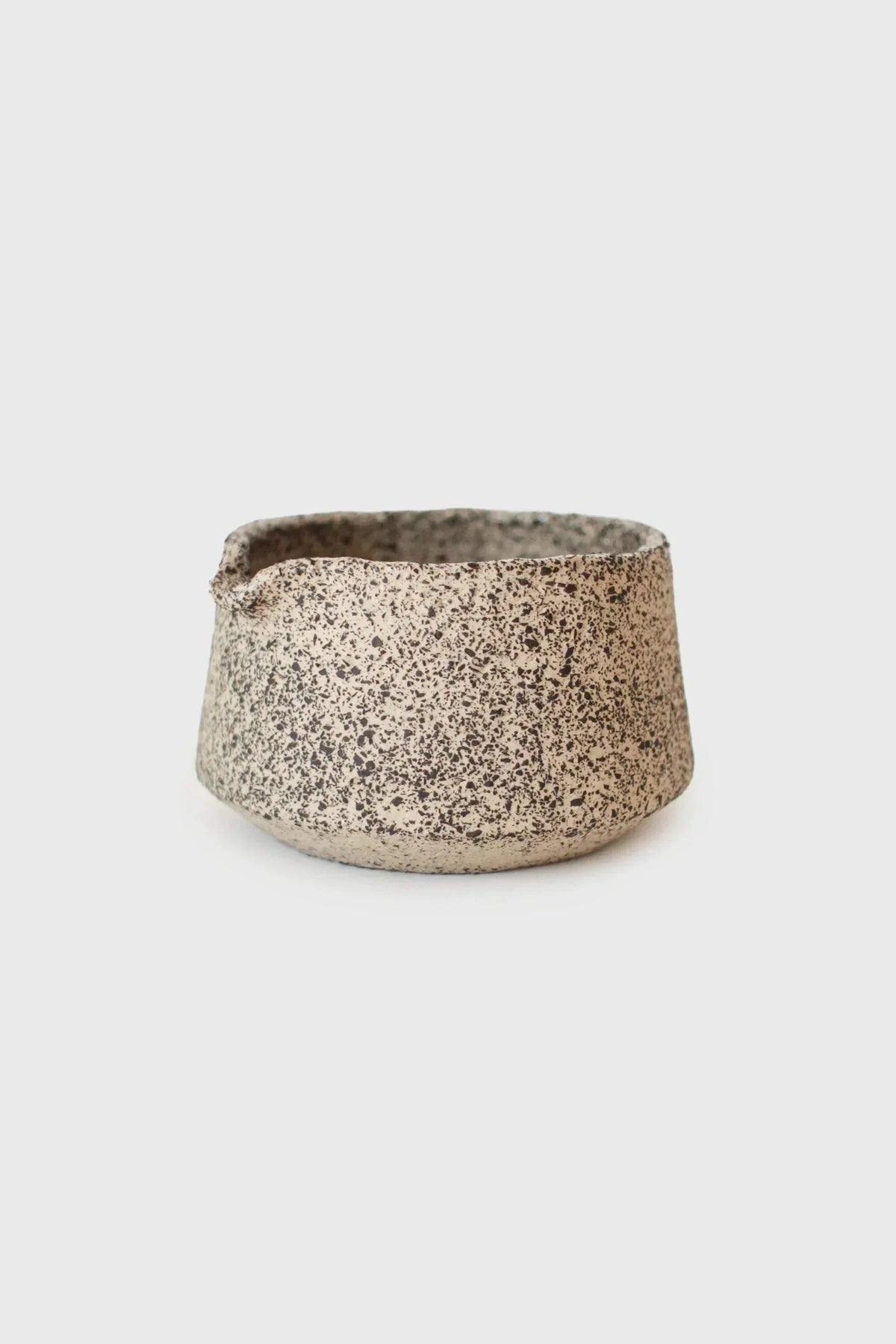 Handmade Stoneware Matcha Bowl in cream with dense dark speckles, a rounded shape, and a subtly uneven rim.