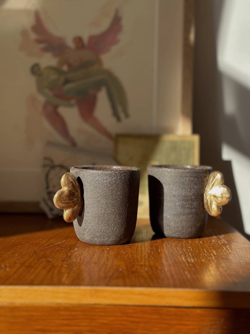 Handmade Stoneware Coffee Cup in dark pumpernickel brown with a textured finish and sculpted gold flower accents.